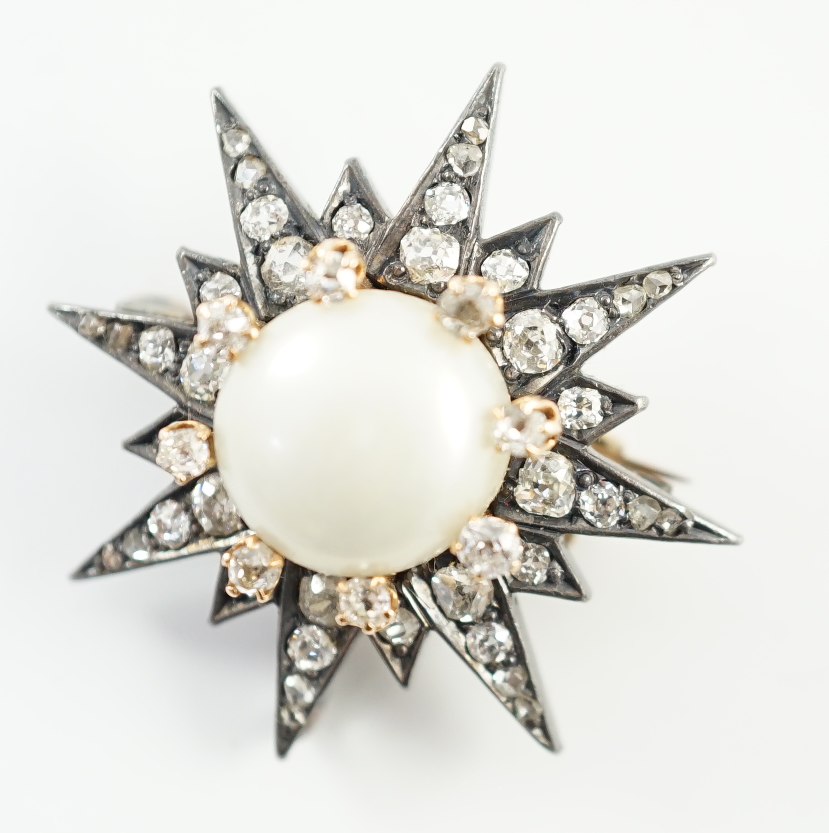 A Victorian gold and silver, button pearl and graduated round and rose cut diamond set cluster starburst brooch